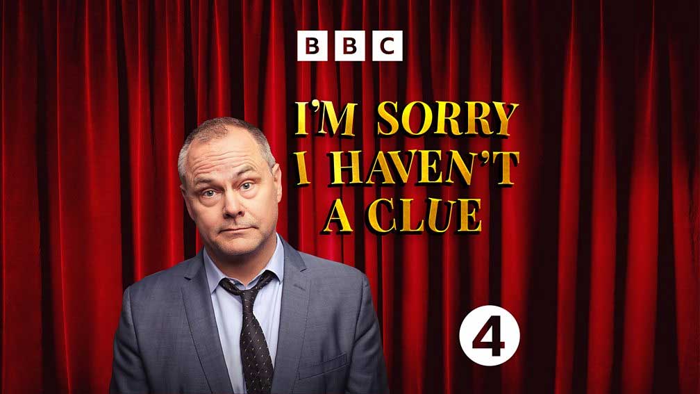 I'm Sorry I Haven't A Clue - yellow text on red curtain background. Jack in suit and loosened tie